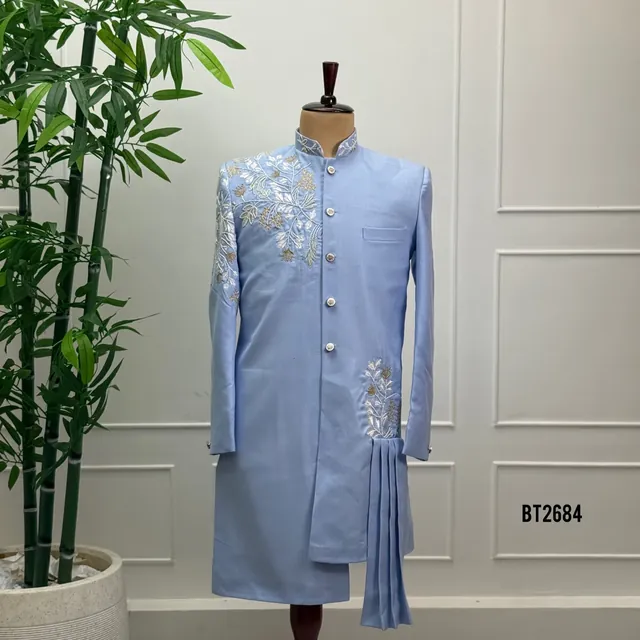 A powder-blue long occasion coat with fine floral embroidery, shown on a dress form