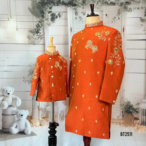 Matching rust father and son coats with gold horse and rose embroidery