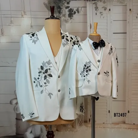 Matching ivory father and son three-piece suits with black and silver floral beadwork